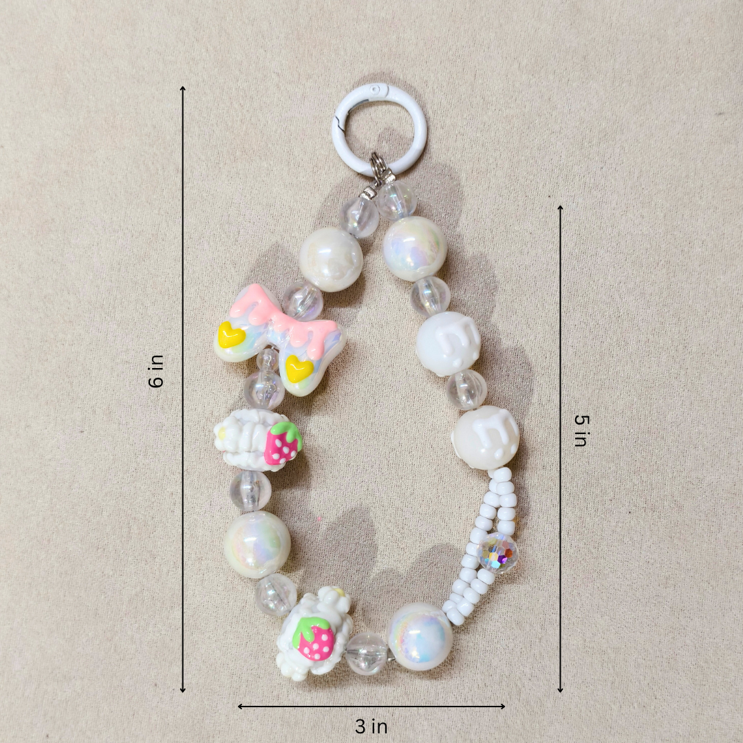 Beaded keychain with decorative elements on a beige background