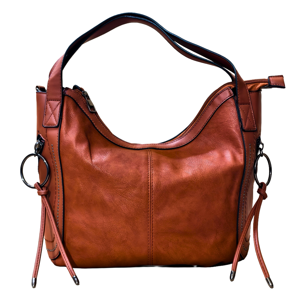 Brown leather handbag with decorative straps on a white background