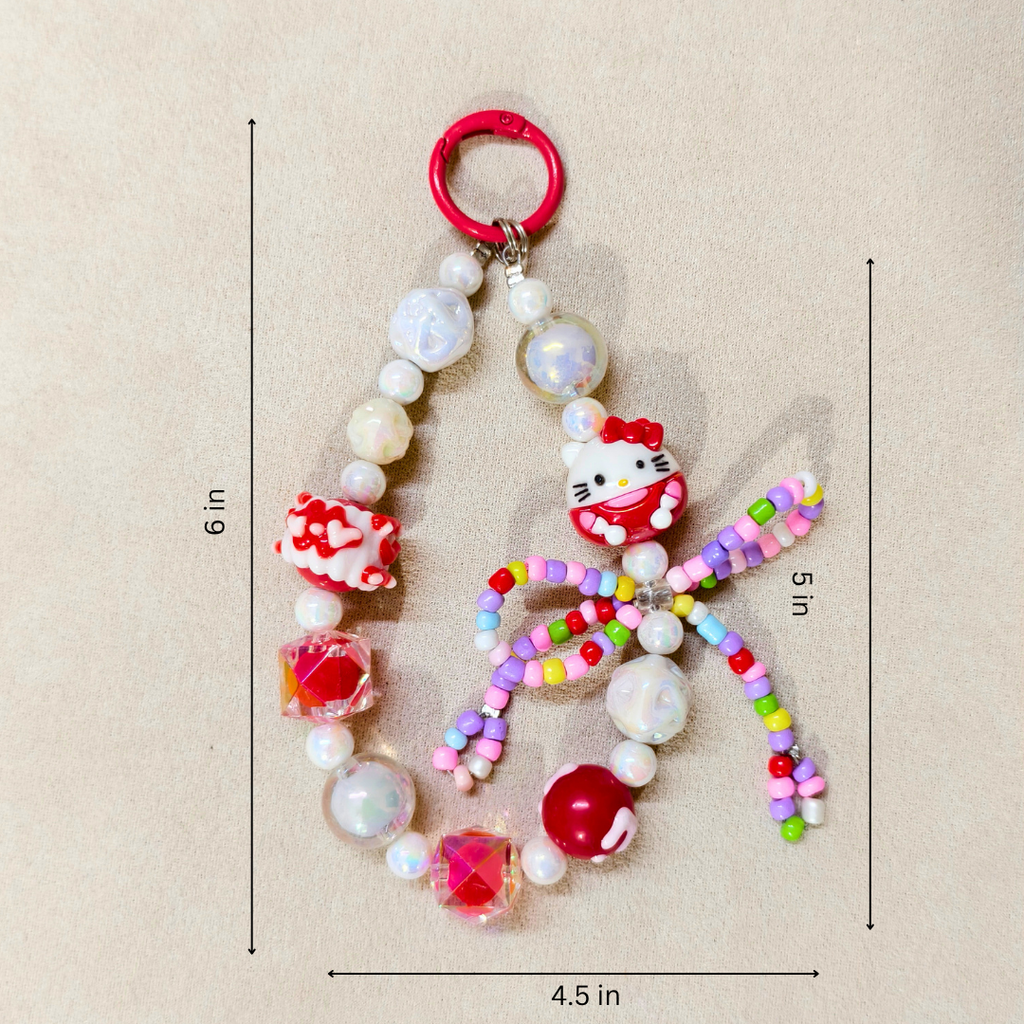 Colorful beaded keychain with Hello Kitty design on a beige background