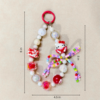 Colorful beaded keychain with Hello Kitty design on a beige background