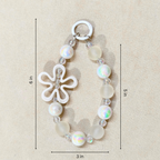 Bracelet with a flower charm and measurements on a beige background