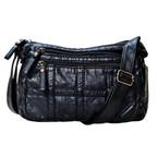 Black leather handbag with gold hardware on a white background