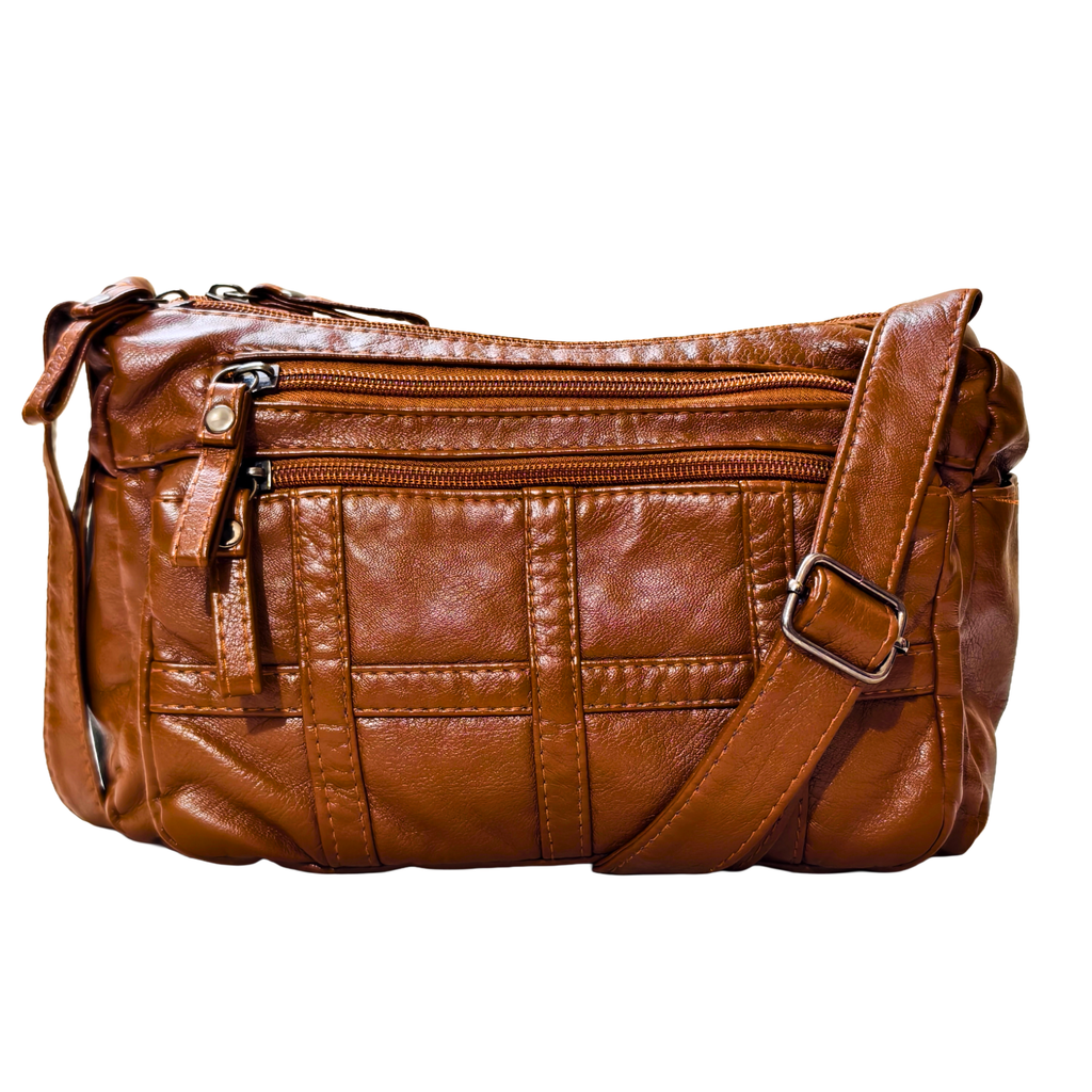Brown leather handbag with multiple zippers on a white background