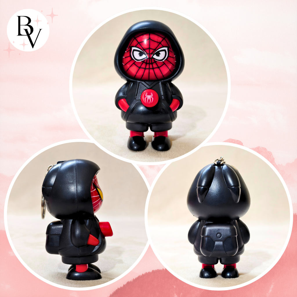 Black and red superhero figurine with a pink background