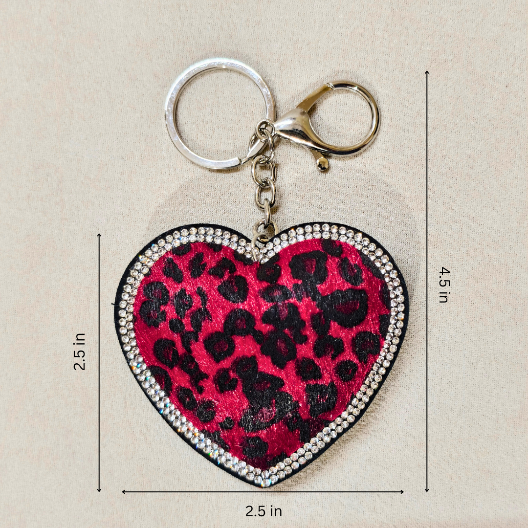 Heart-shaped keychain with leopard print design and measurements on a beige background