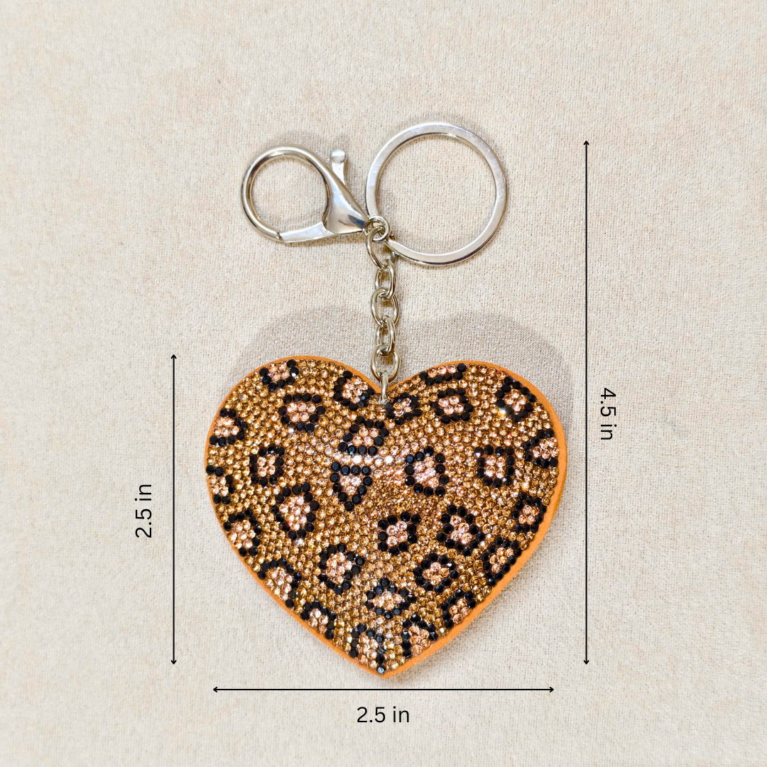Heart-shaped keychain with leopard print design on a beige background with measurements.