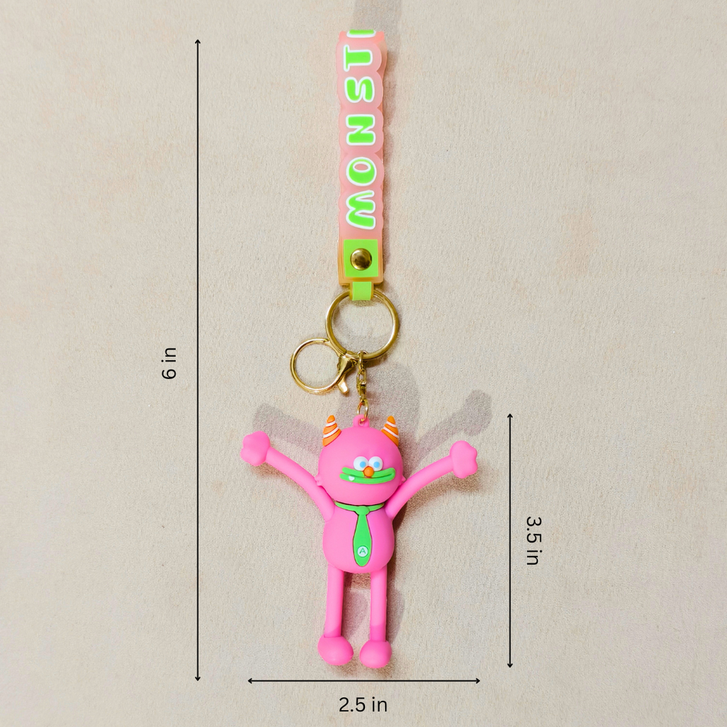 Pink monster-shaped keychain with a green necktie and gold key rings, shown with dimension lines indicating 6 in height, 3.5 in width, and 2.