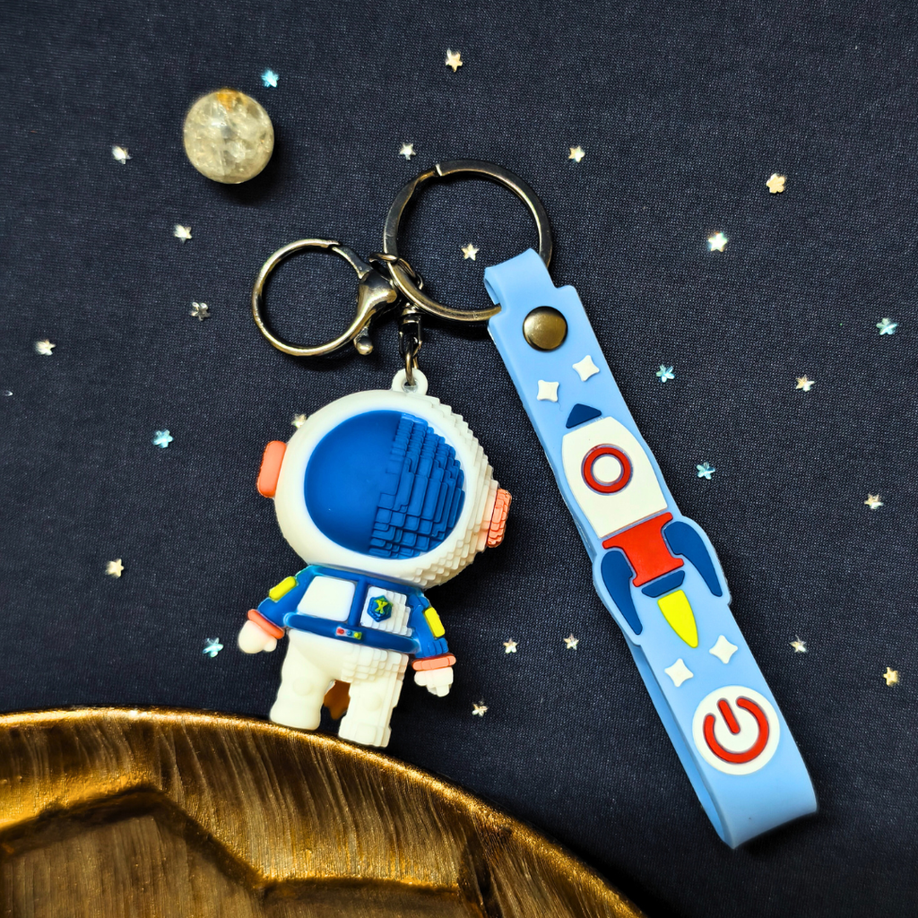 Keychain with astronaut design on a dark space-themed background