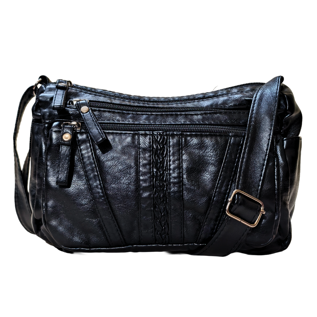 Black leather handbag with multiple zippers on a white background