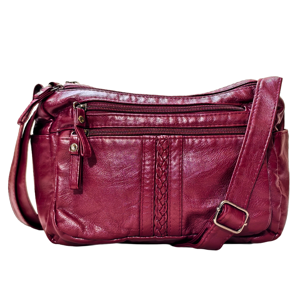 Red leather handbag with braided detail on a white background