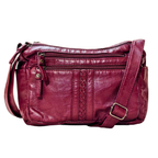 Red leather handbag with braided detail on a white background