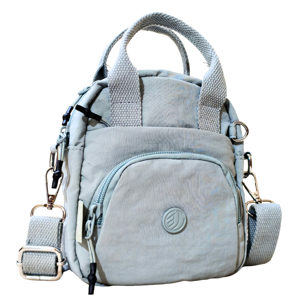 Light blue backpack with multiple straps and zippers on a white background