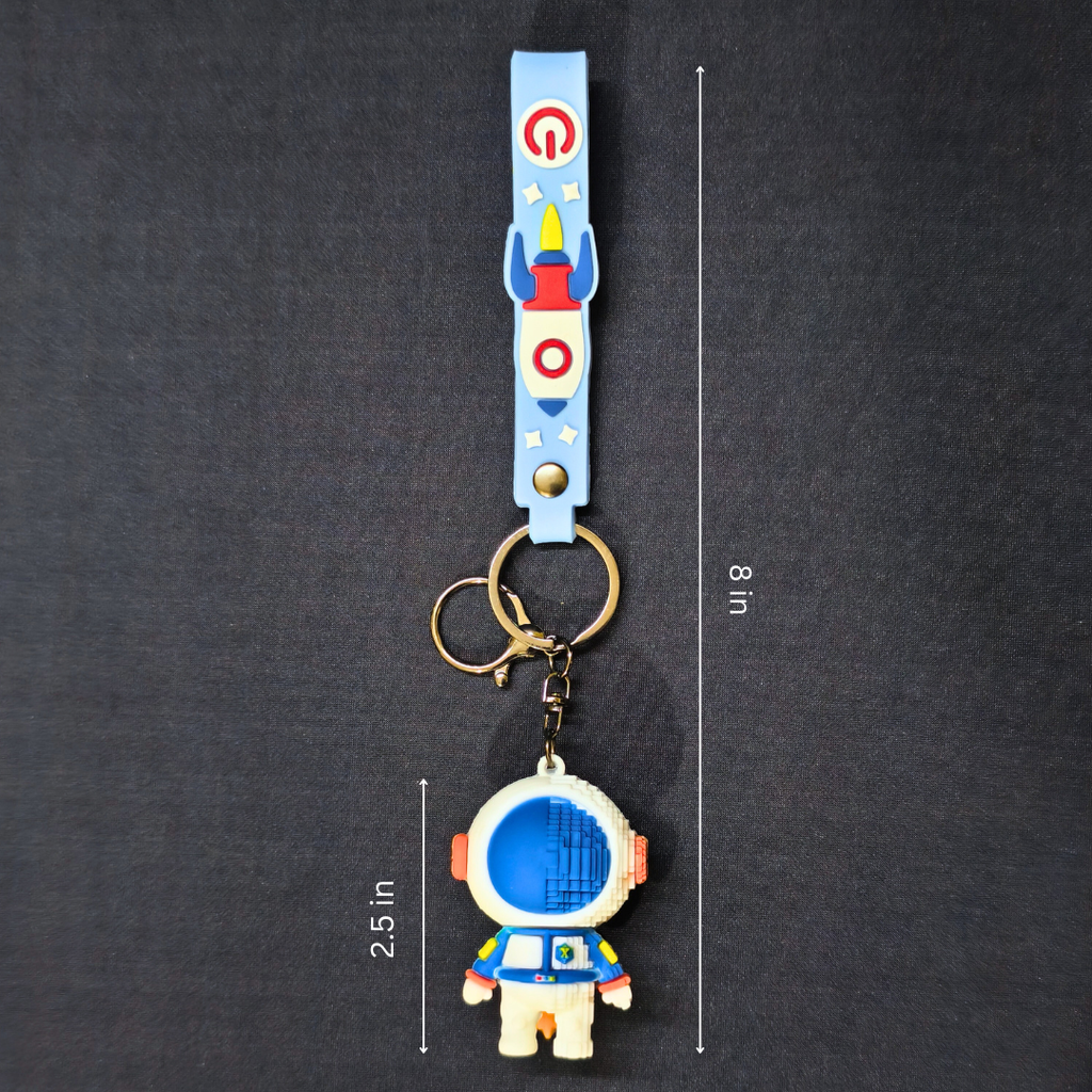 Keychain with astronaut design and measurement details on a dark background