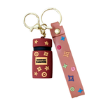 Keychain with a small container and pink strap on a white background