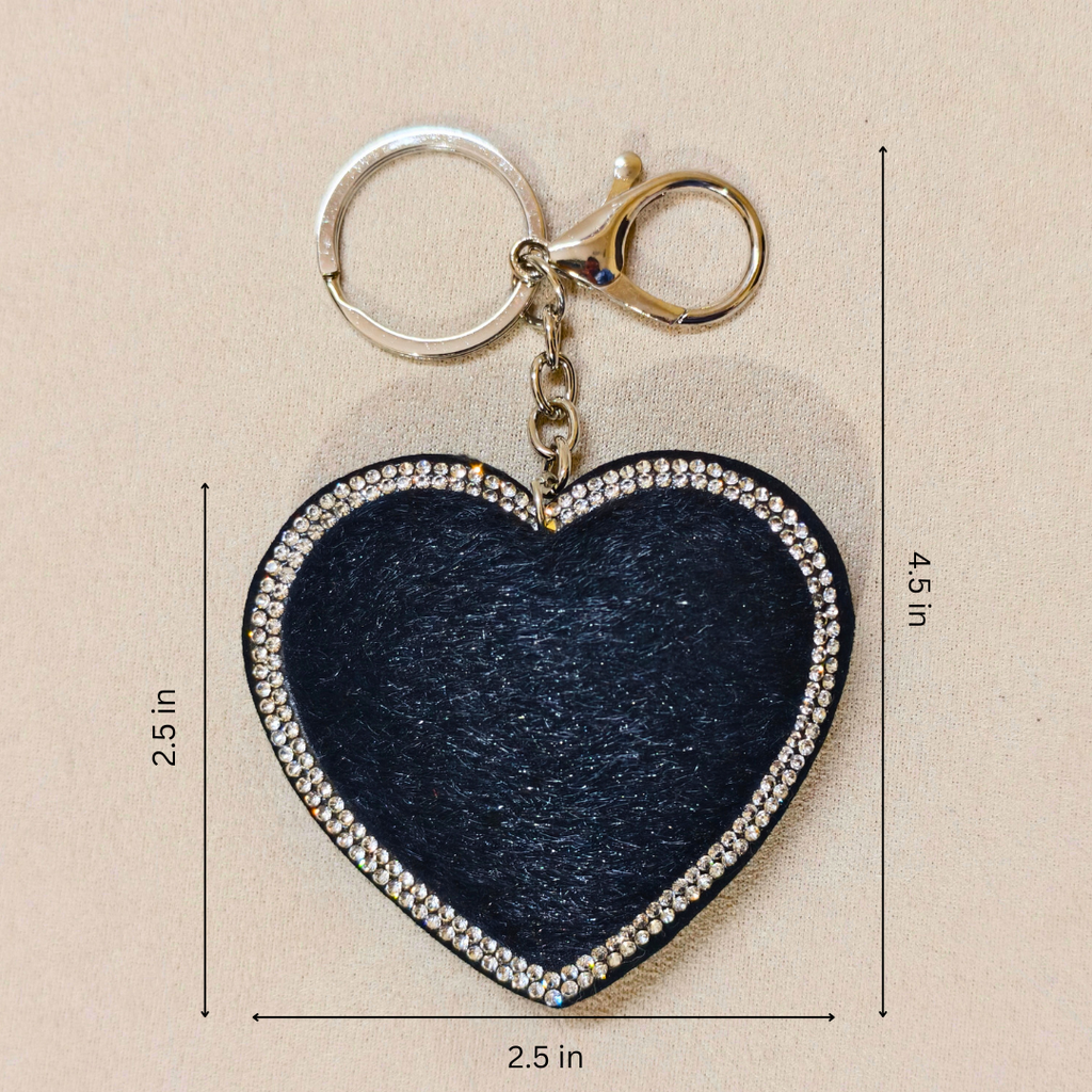 Heart-shaped keychain with measurements on a beige background