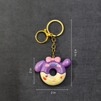 Keychain with donut design and measurements on a dark background