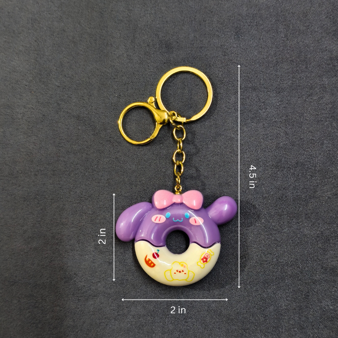 Keychain with donut design and measurements on a dark background