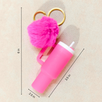Pink insulated tumbler keychain with a fluffy pom-pom and gold key rings, shown on a beige background with dimension lines and measurements.