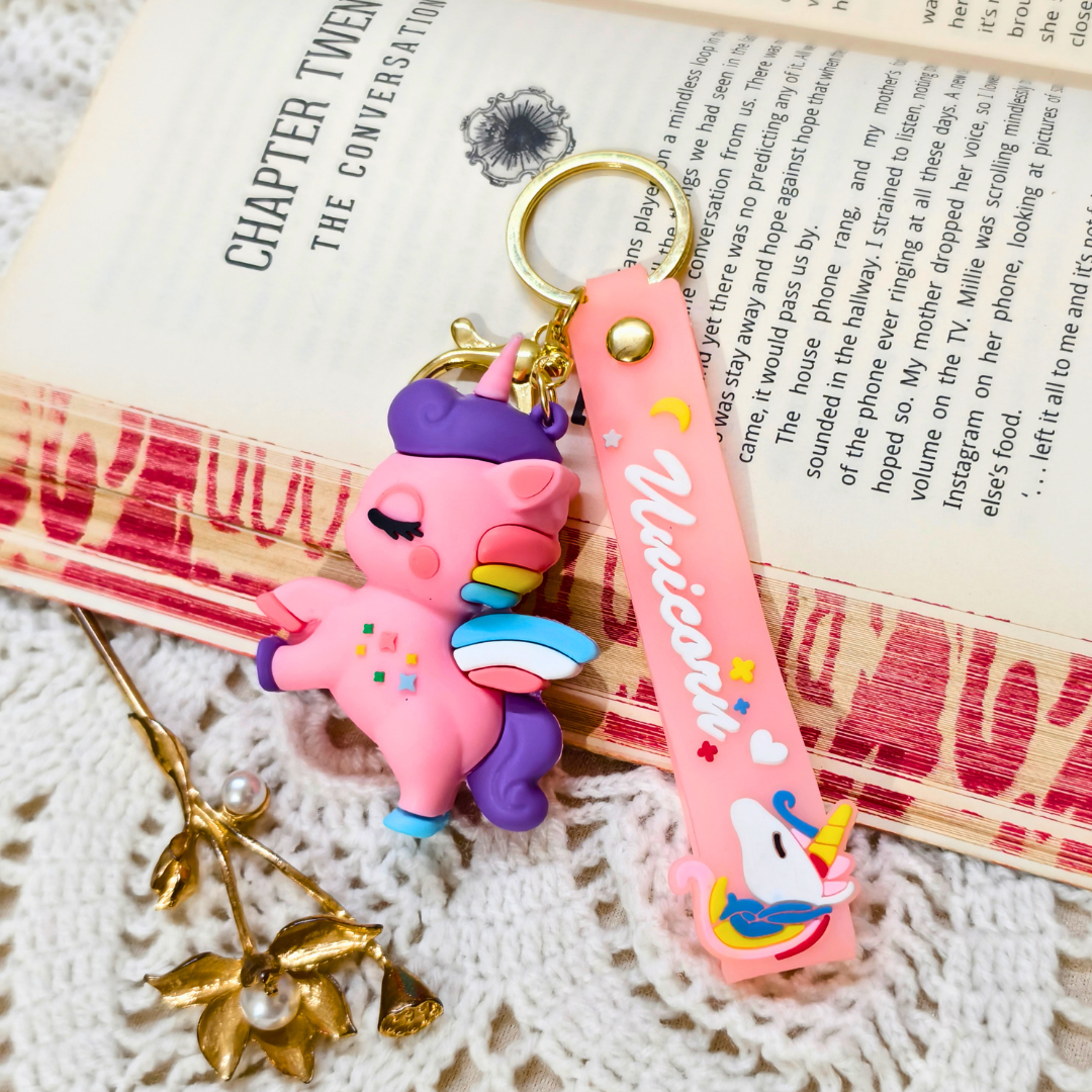 Colorful keychain with a unicorn design on an open book