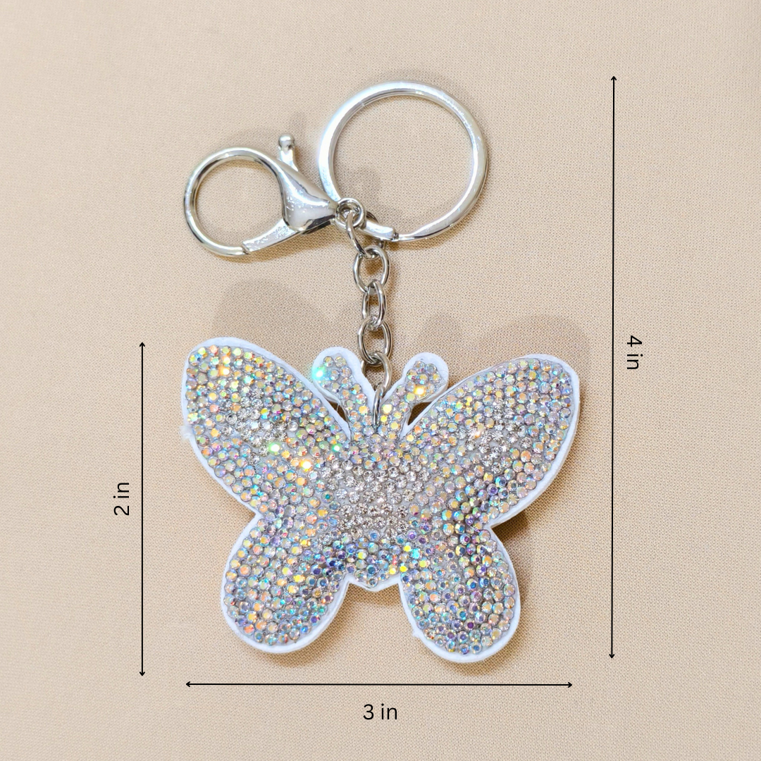white butterfly with measurements along with a metal latch in front of a beige background