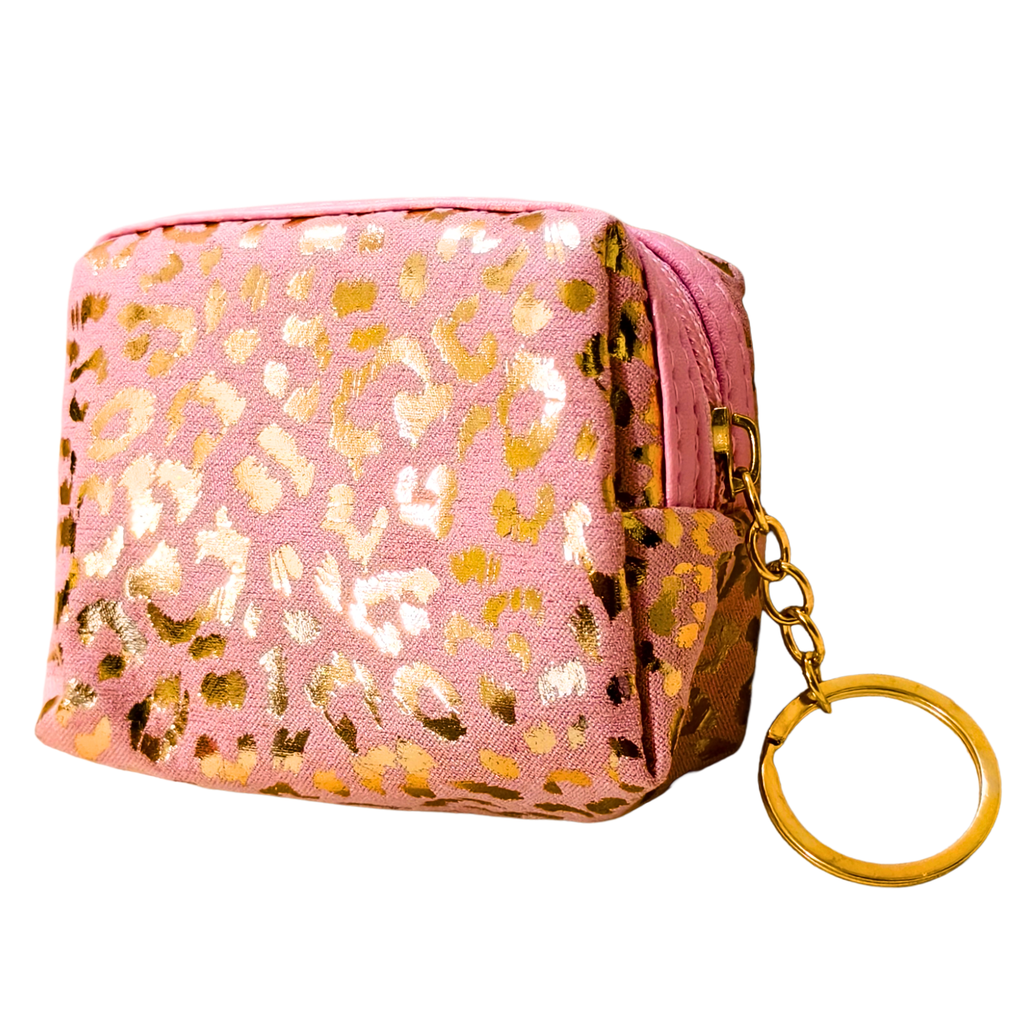 Pink pouch with gold leopard print pattern and matching keychain on a white background