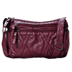 Maroon leather handbag with multiple zippers on a white background