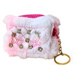 Fluffy pink and white pouch with decorative elements on a white background