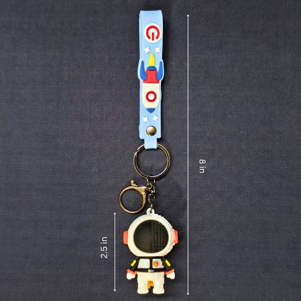 Keychain with astronaut design and measurement details on a dark background
