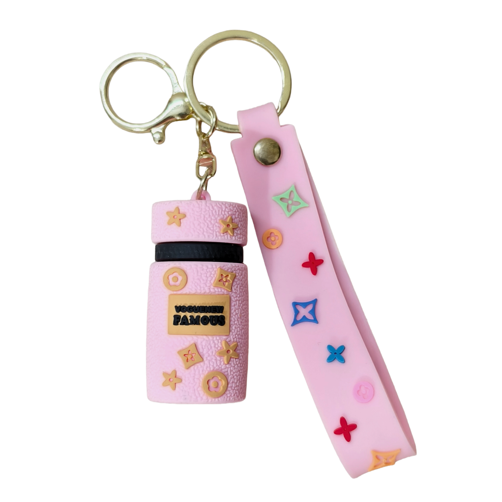 Pink keychain with decorative elements on a white background