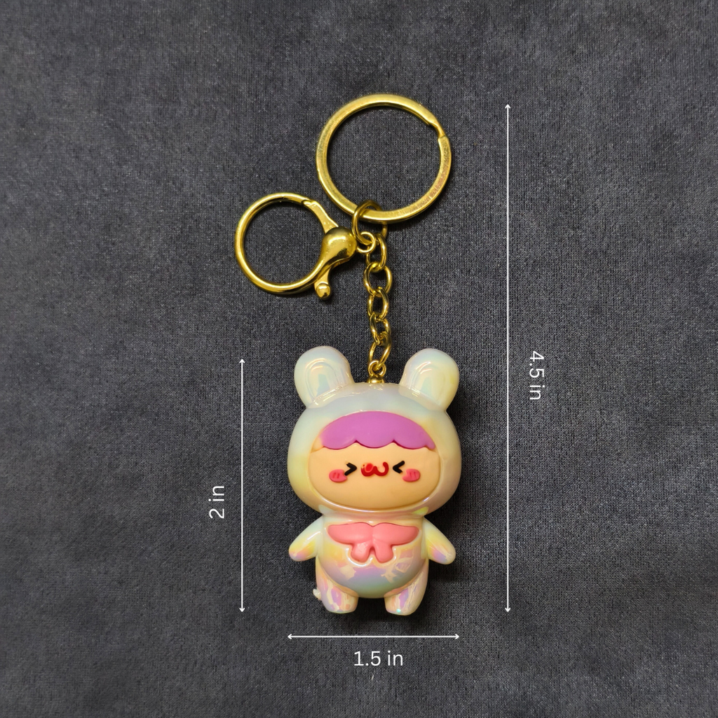 Cartoon character keychain with gold chain on a dark gray background