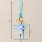 A light blue monster-shaped keychain charm with gold metal rings and a turquoise strap printed with the word 'MONSTERS' in light blue letters. The image includes dimension lines and text indicating the product's measurements: 6 in total height, 3.