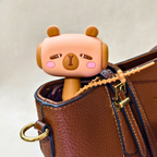 Cute cartoon character peeking out from a brown leather bag