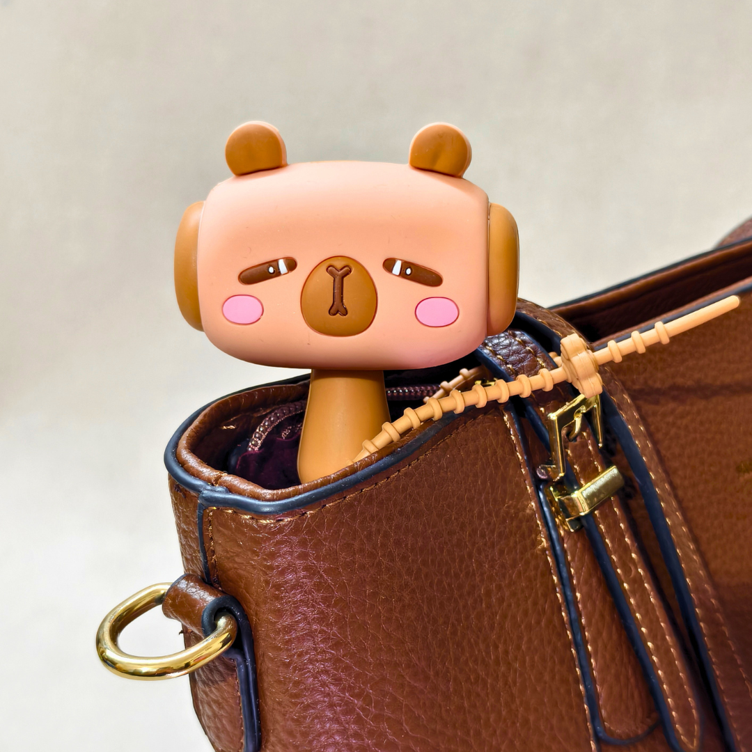 Cute cartoon character peeking out from a brown leather bag
