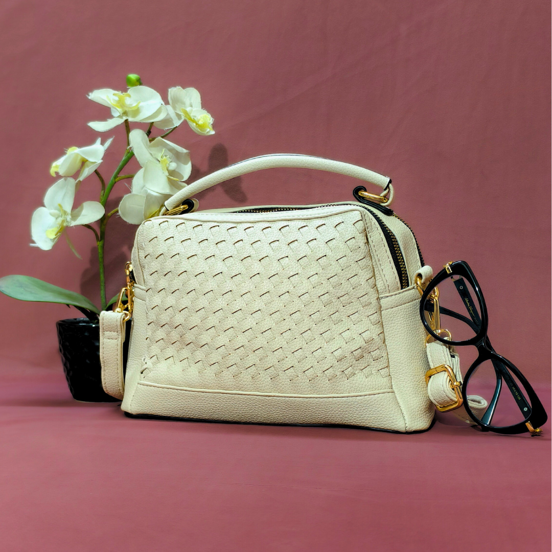Beige handbag with woven pattern on a pink background