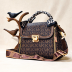 Designer handbag with brand logo on a neutral background