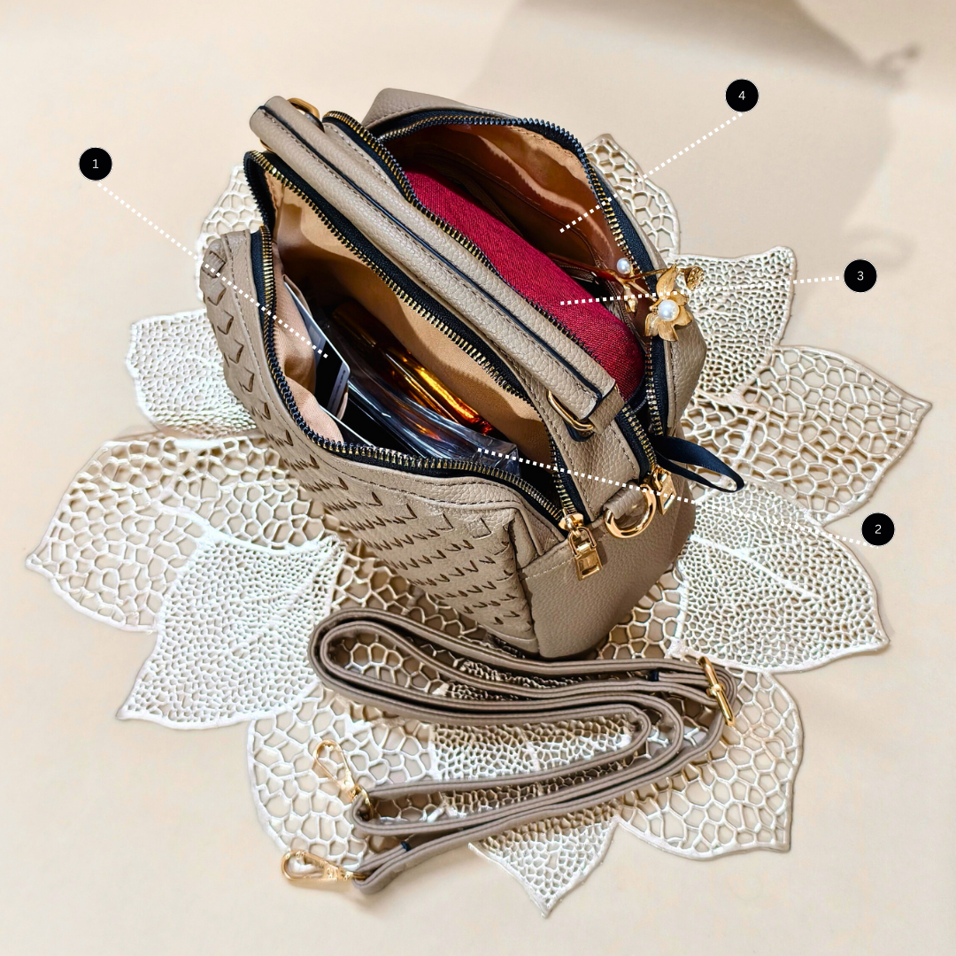 Beige handbag with gold accents on a decorative white background