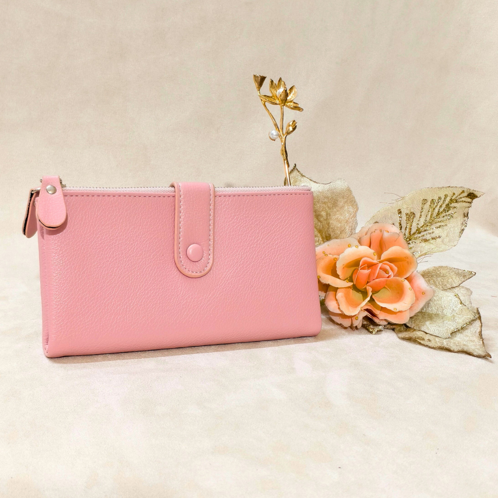 Pink wallet on a beige surface with decorative flowers