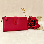 Red wallet with a red rose on a beige background