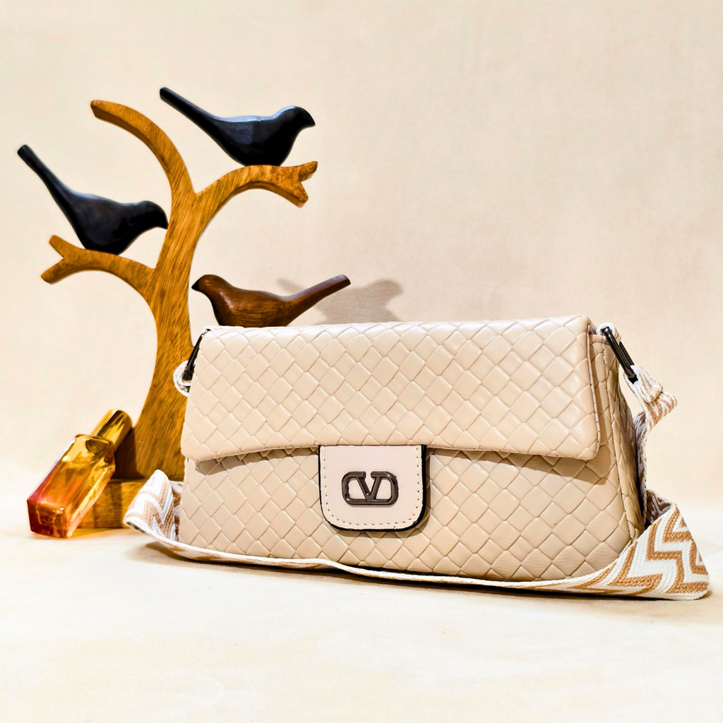 Beige quilted handbag with a brand logo on a beige background