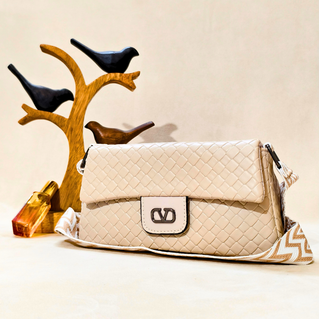 Beige quilted handbag with a brand logo on a beige background