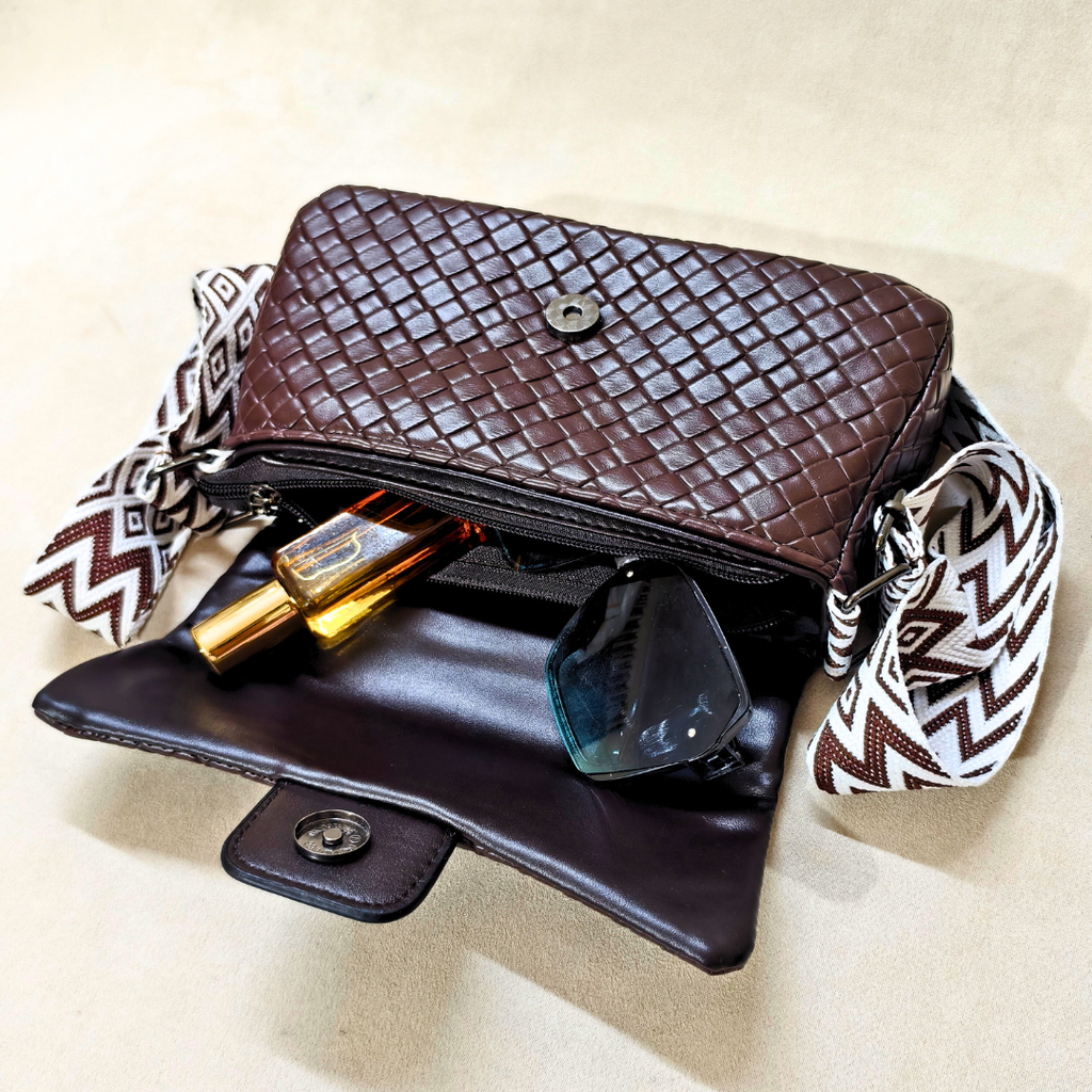 Brown woven handbag with a strap on a beige background