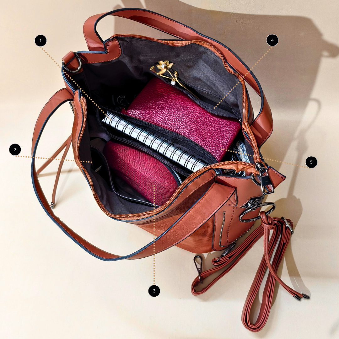 Brown leather handbag with open design showing interior compartments on a beige background