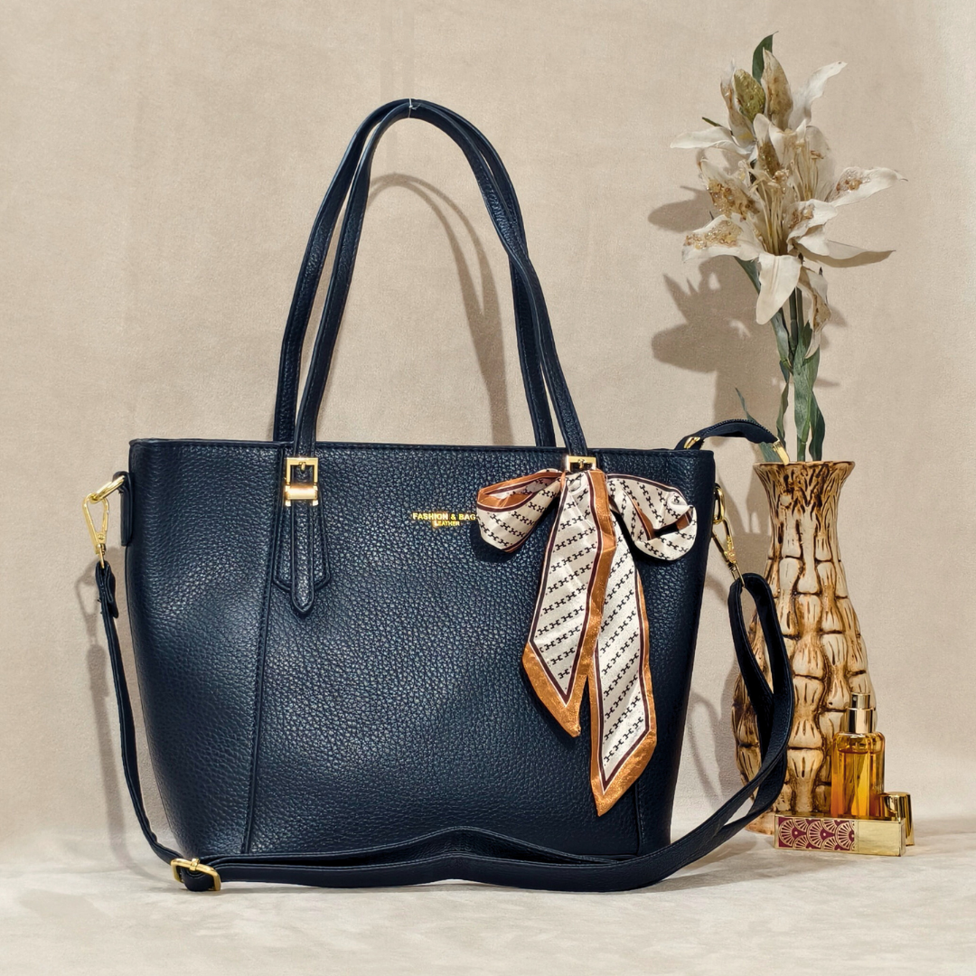 Blue handbag with a decorative ribbon on a beige background