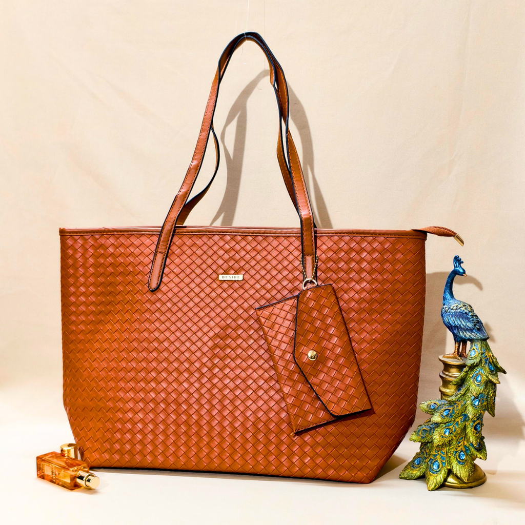 Brown woven handbag with a decorative peacock charm on a beige background