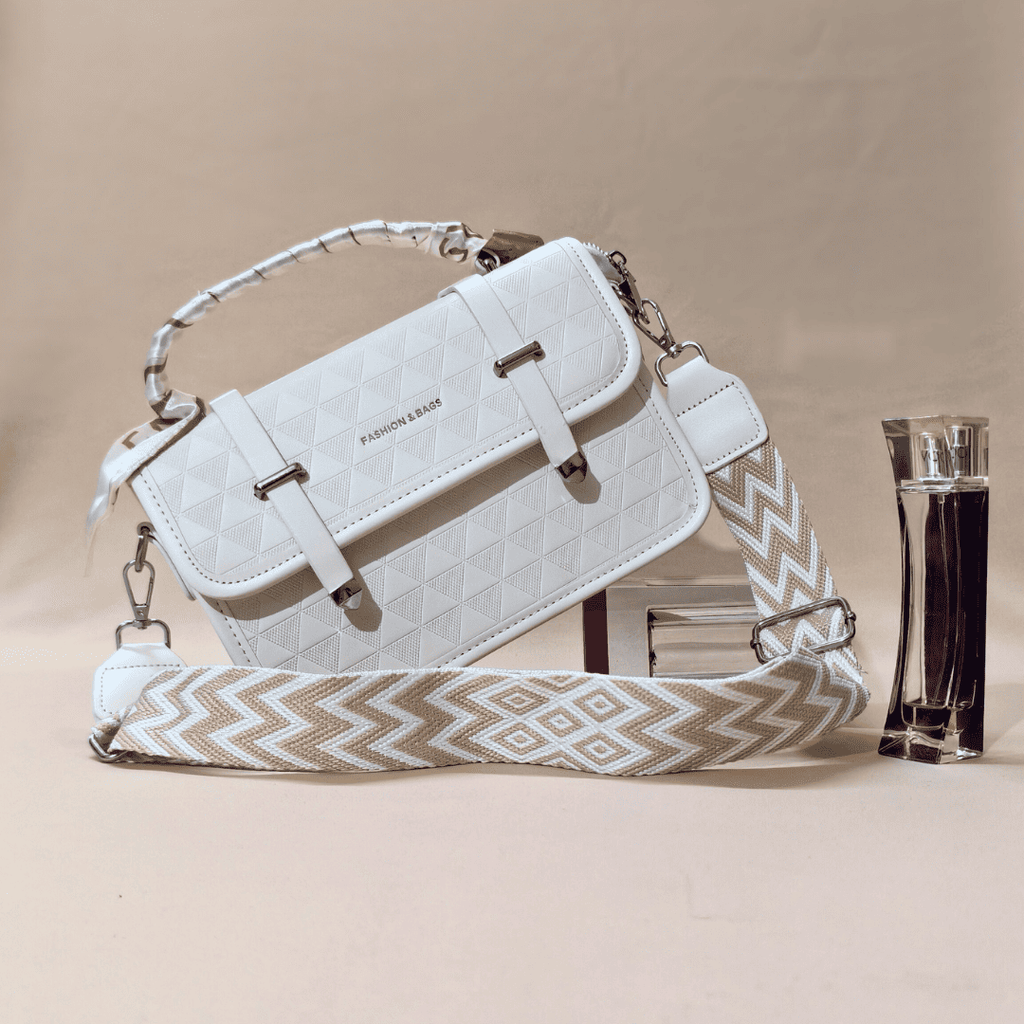 White handbag with a patterned strap on a beige background