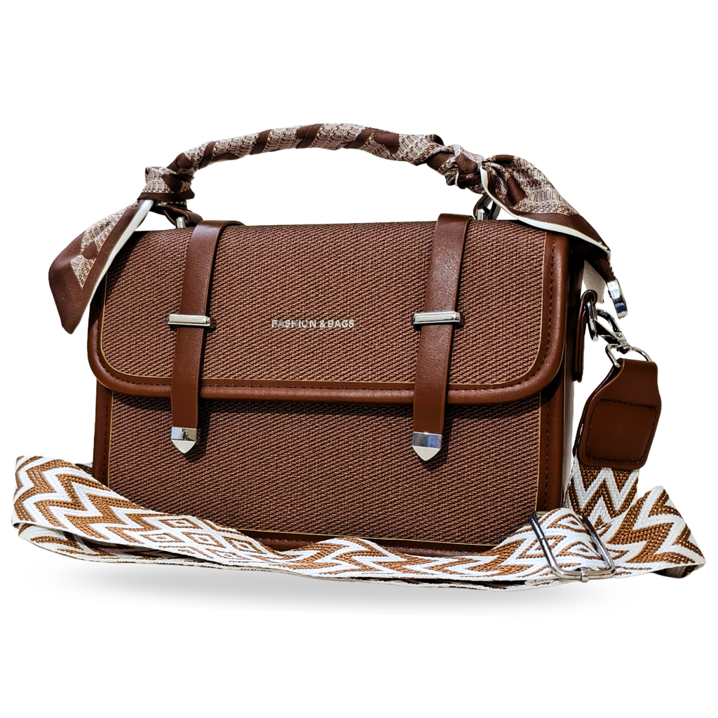 Brown handbag with a patterned strap on a white background