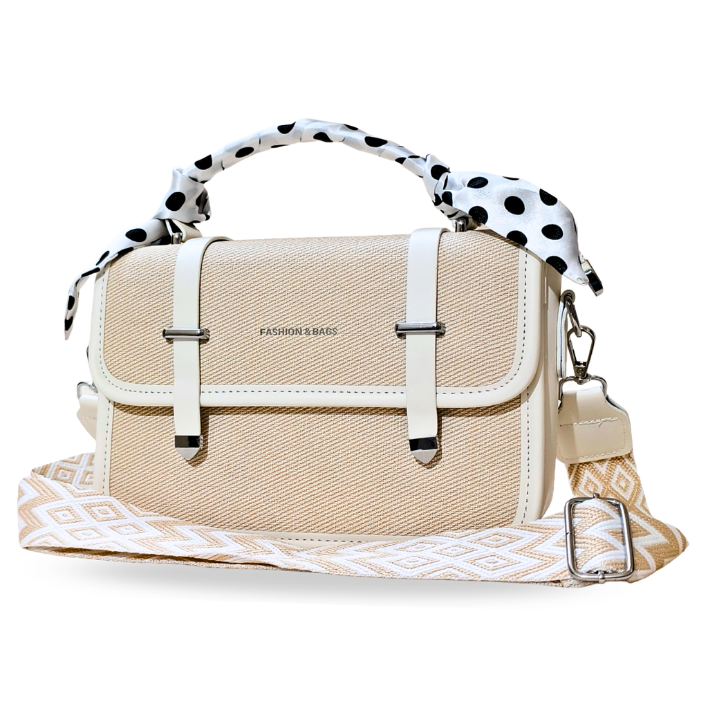 Beige handbag with polka dot handle and patterned strap on a white background