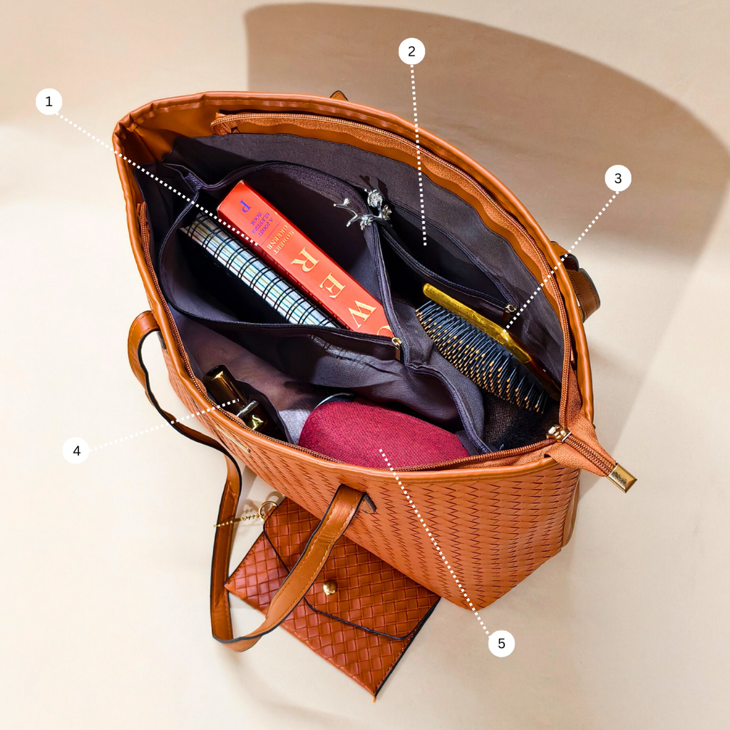 Open brown leather handbag with items inside on a beige background