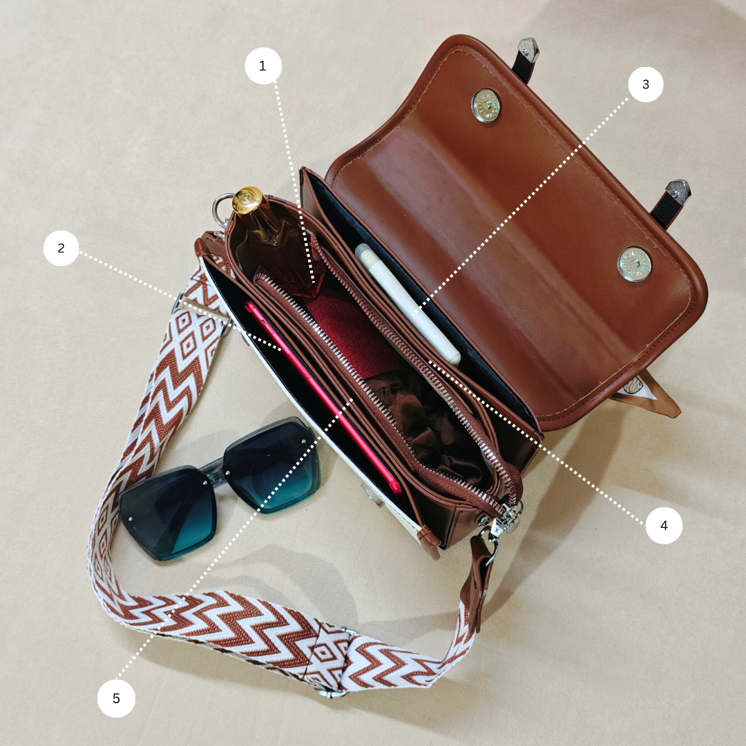 Brown handbag with a strap, sunglasses, and a phone on a beige background