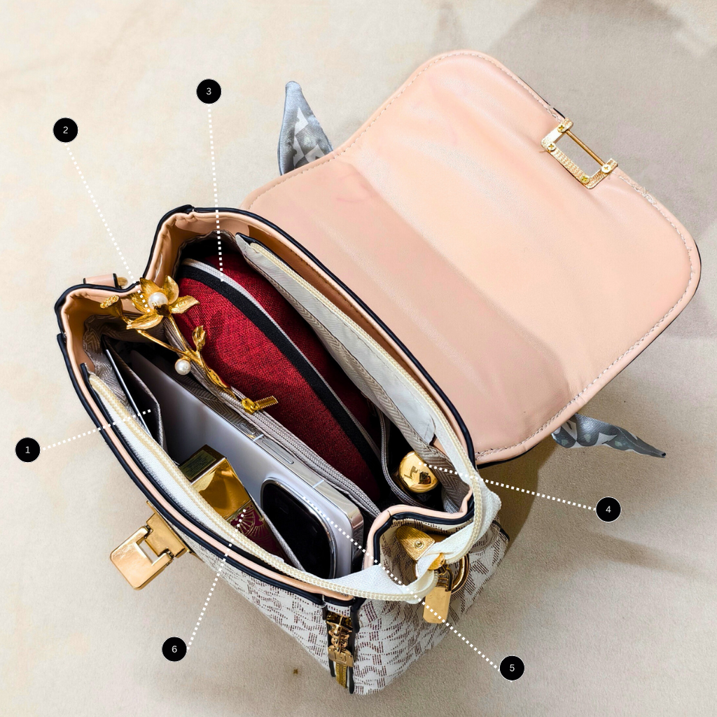 Open beige handbag with gold accents on a beige background